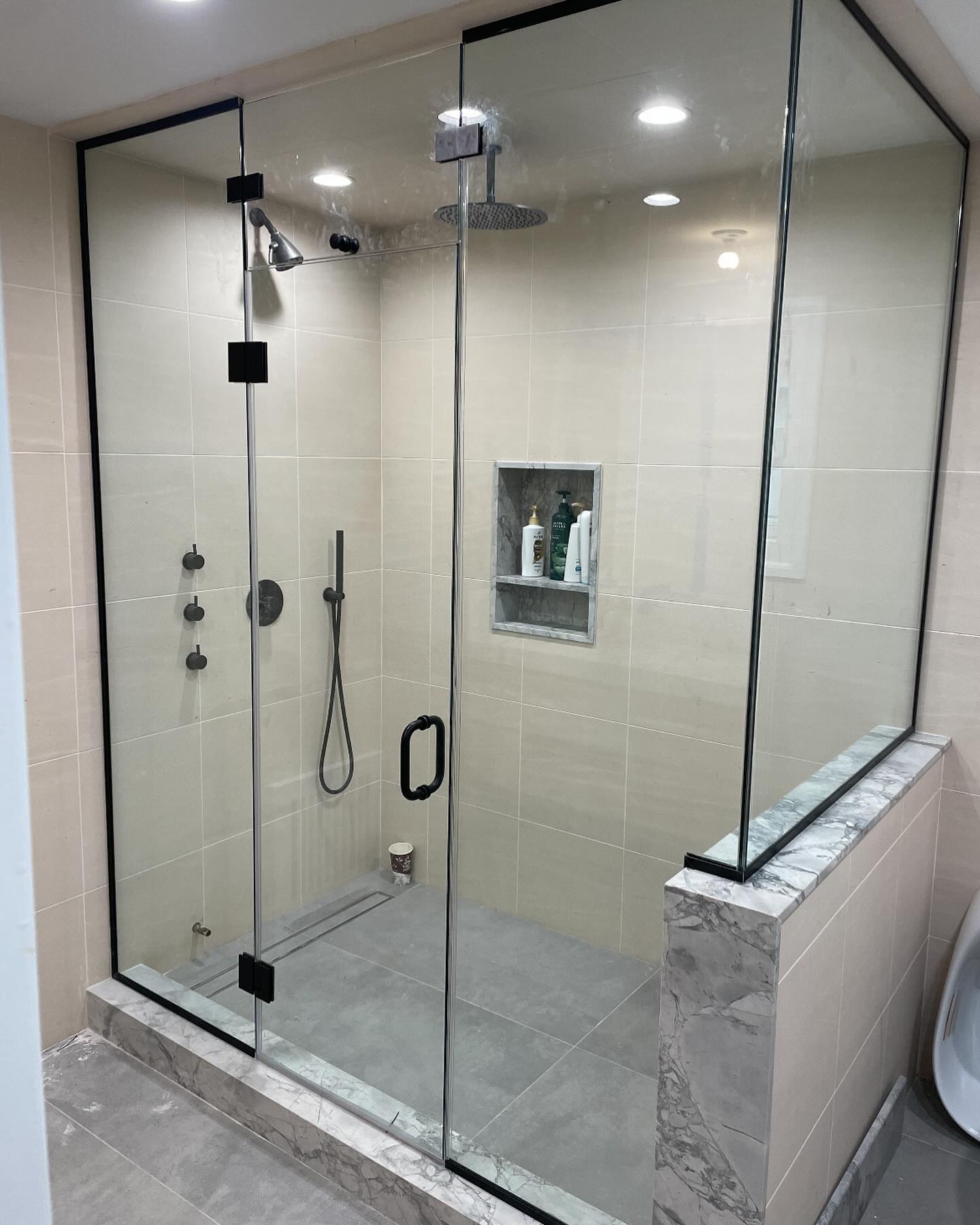 Frameless shower door installation by Ray's Glass Brooklyn